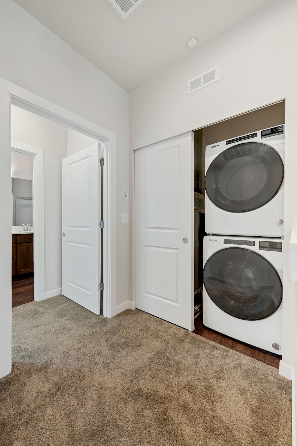 an empty laundry room with a washer and dryer in it
