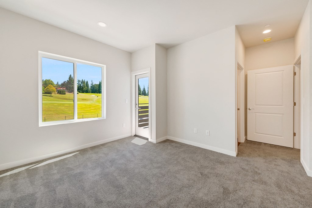 an empty room with a window and a door