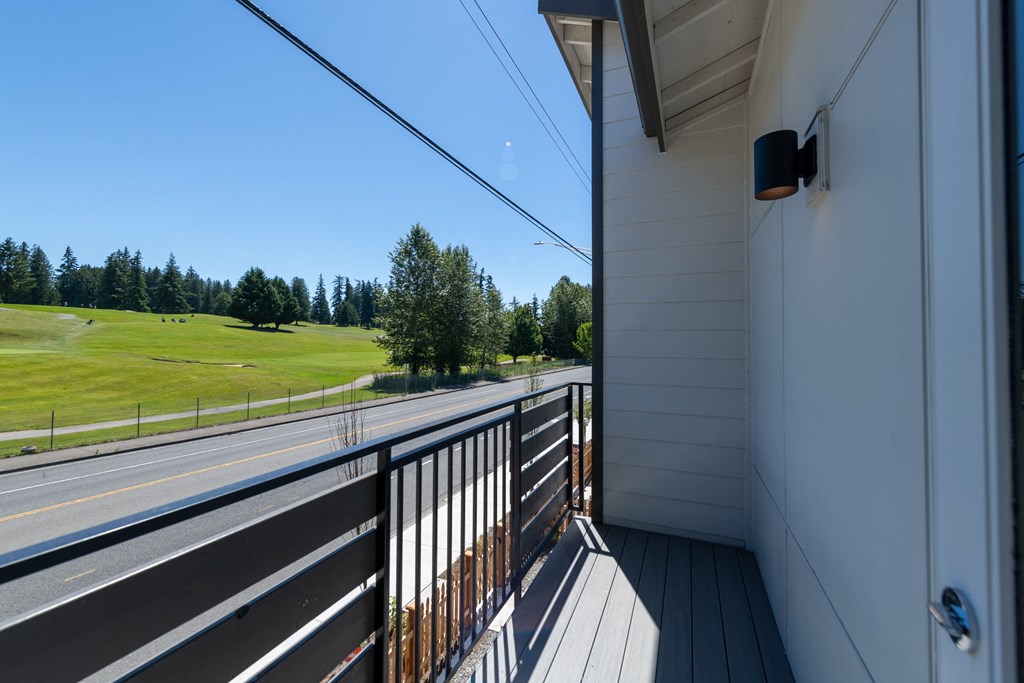 the view from the balcony of a house on the side of a highway