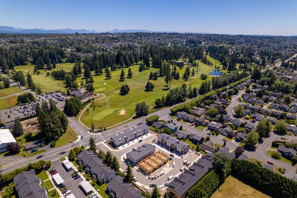 an aerial view of a neighborhood with houses and a golf course