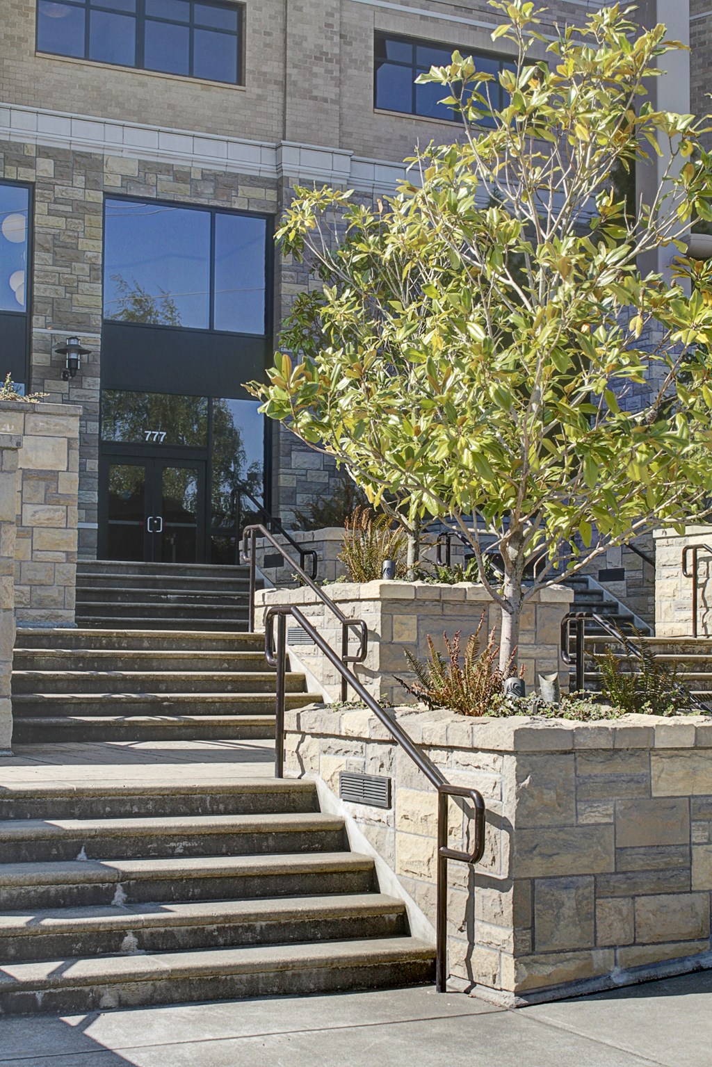 a set of stairs in front of a building with trees