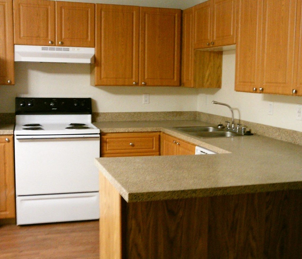 a kitchen with an island and a stove and a sink