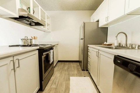 a kitchen with stainless steel appliances and white cabinets
