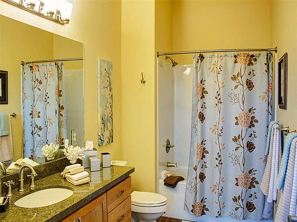 a bathroom with a shower toilet sink and a mirror