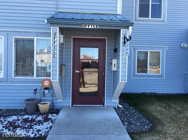 a blue house with a red door and a sidewalk