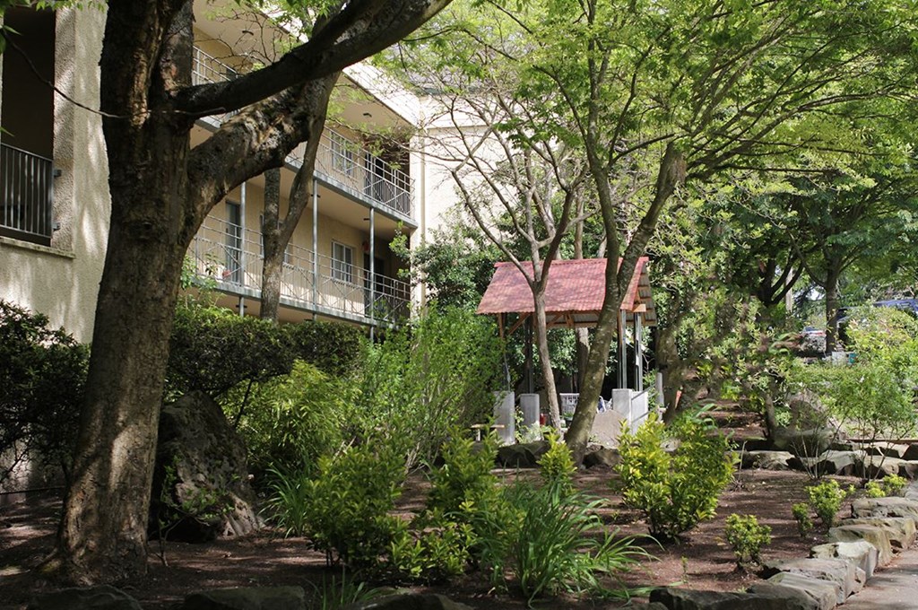 a house with a porch and a garden in front of it