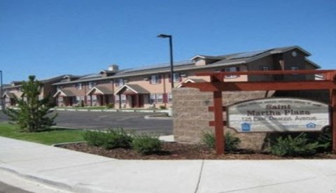 a building with a sign on the side of a sidewalk