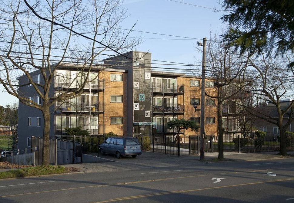A large building with a parking lot in front of it.