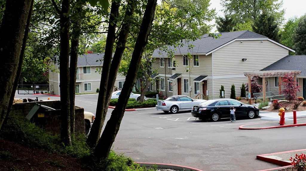 a parking lot with cars in front of houses