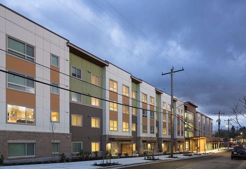 a row of apartment buildings on a snowy street