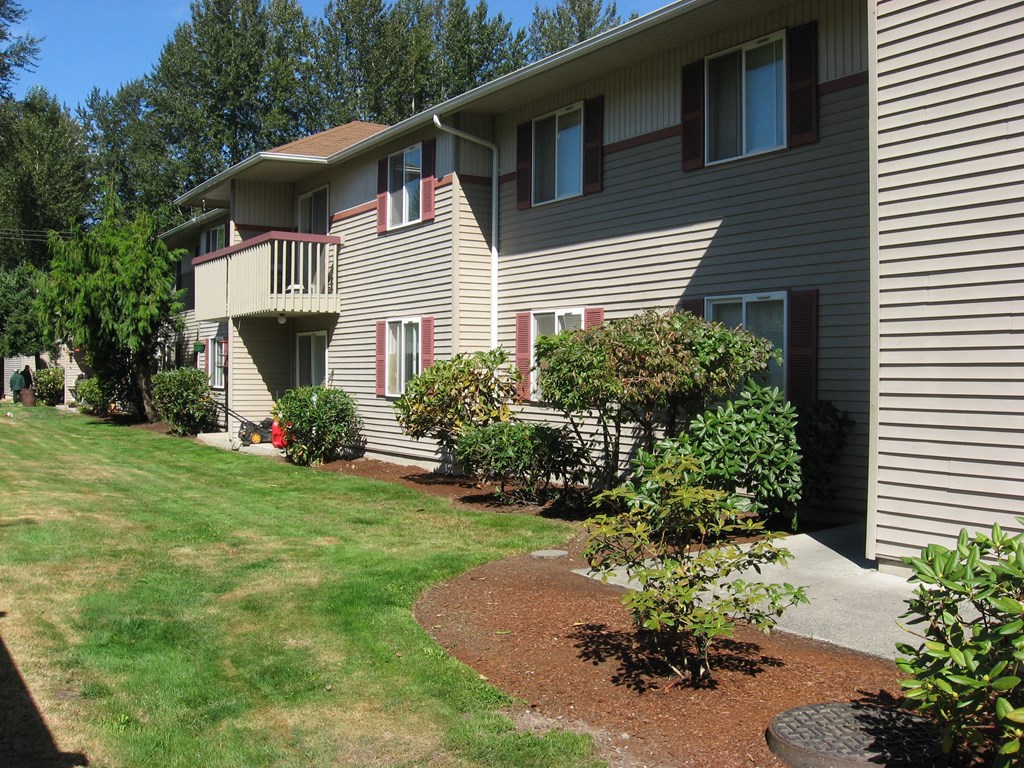 a view of a house with a yard in front of it