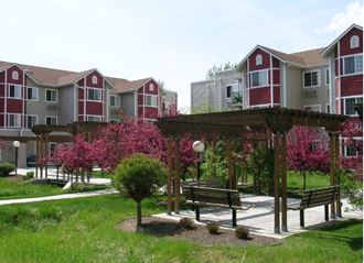 a group of houses with a park with benches