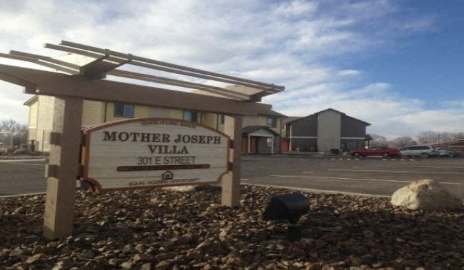 a sign for mother oval street in front of a building