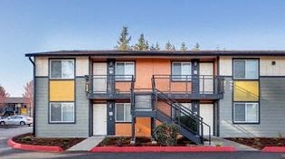 the front of a building with stairs in front of it