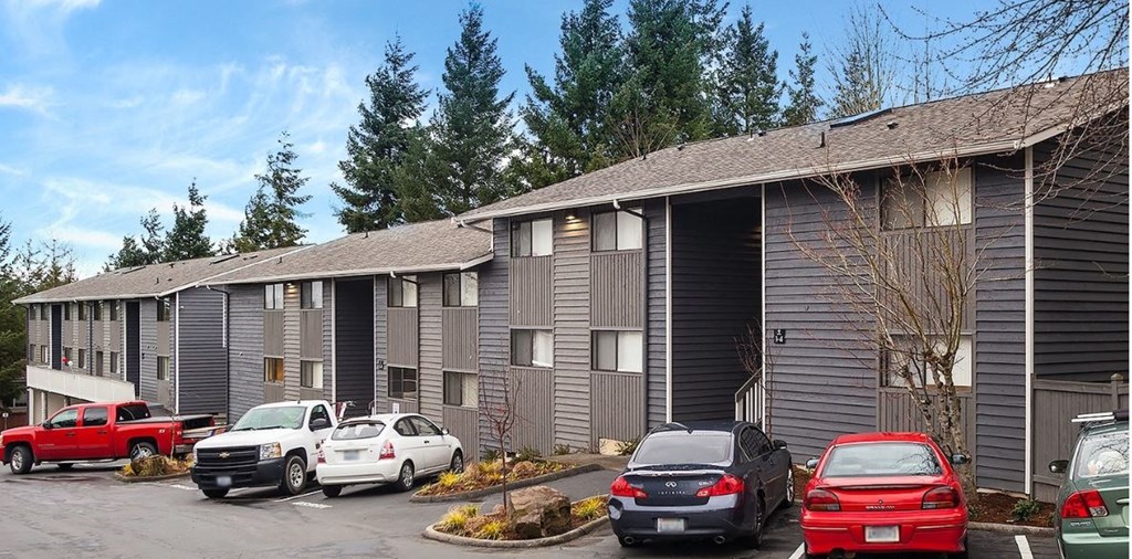 a building with cars parked in a parking lot