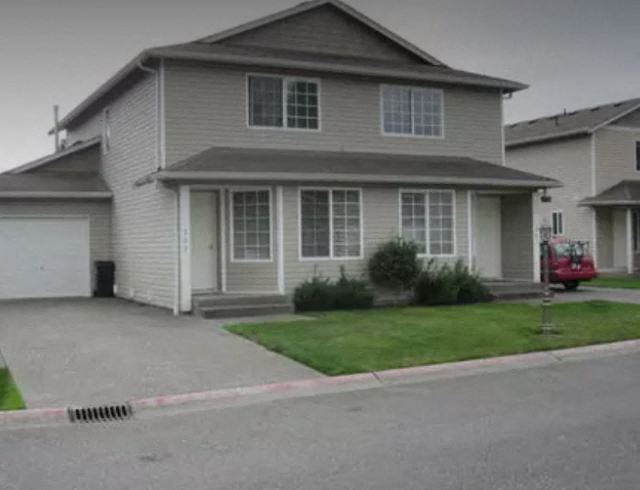 a house with a red truck parked in front of it