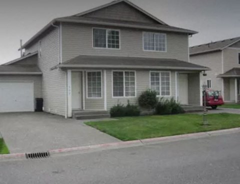 a house with a red truck parked in front of it