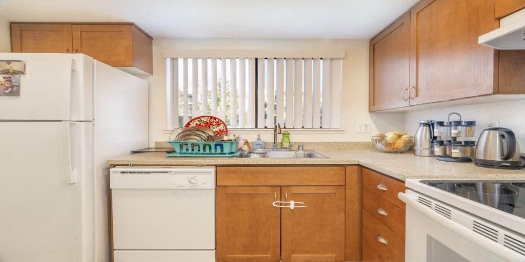 a kitchen with white appliances and wooden cabinets