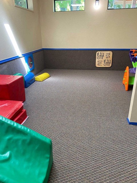 a room with toys and a sign on the floor