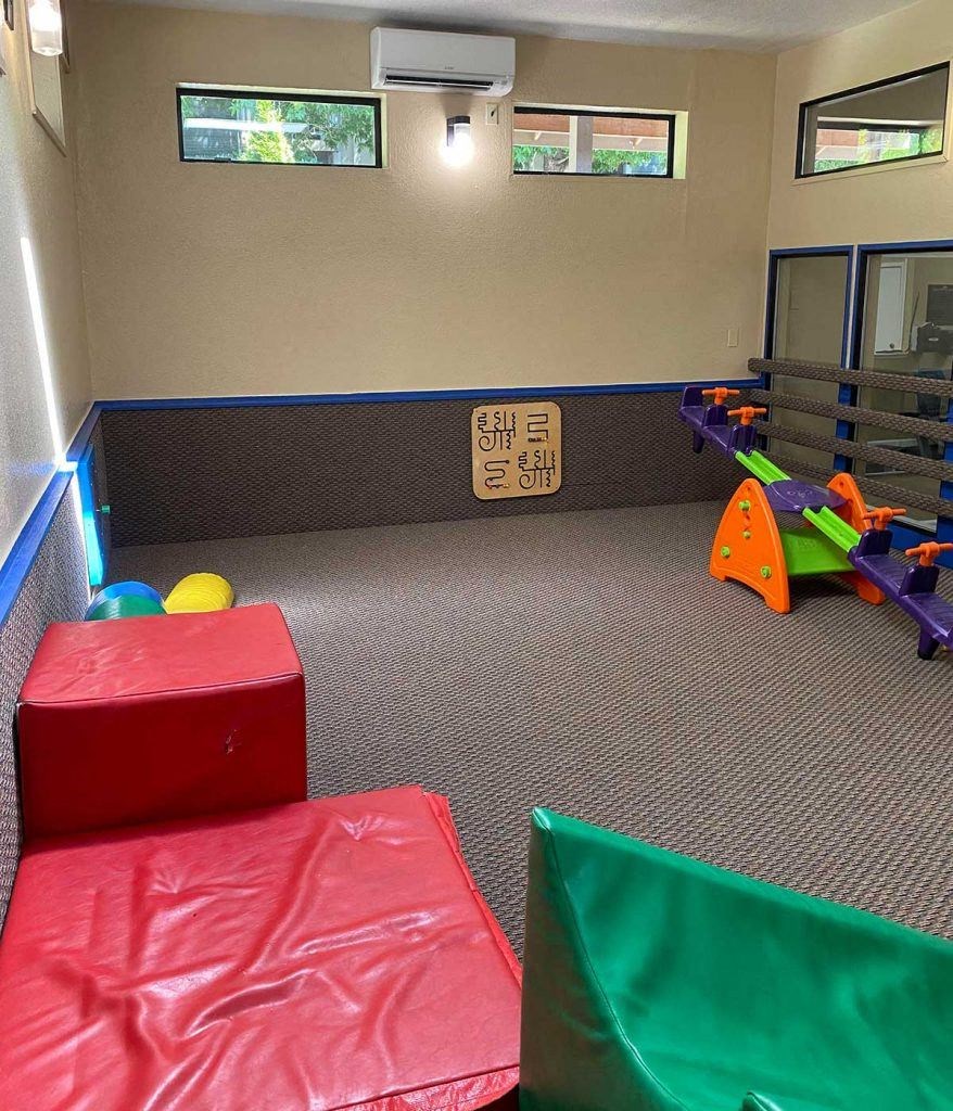 a childs play room with toys and couches