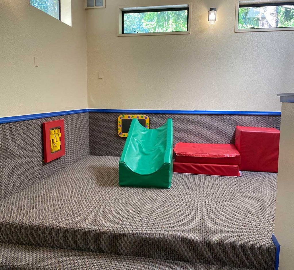a room with three stools and a green chair
