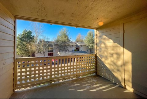 a balcony with a view of a house and trees