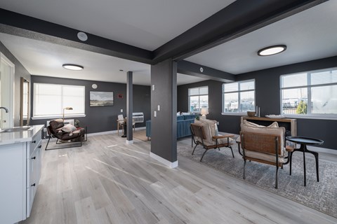 A modern living room with a kitchen area and a dining table.