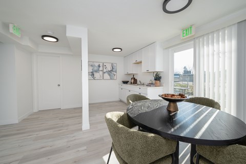 A modern dining room with a round table and chairs.