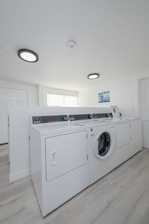 A white laundry room with a washer and dryer.