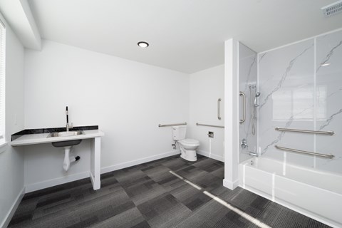 A bathroom with a sink, toilet, and bathtub.