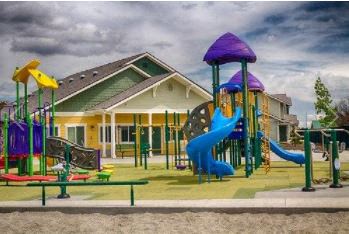 a playground with slides and a house