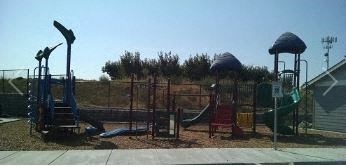 a playground with a swing set and slides