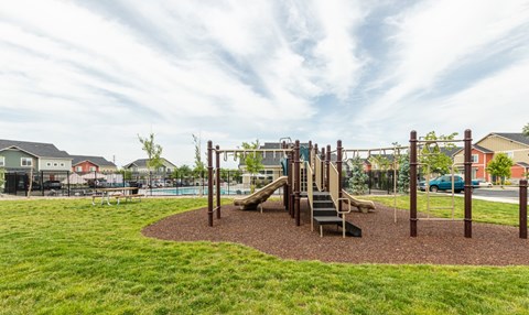 A playground with a slide and swings.