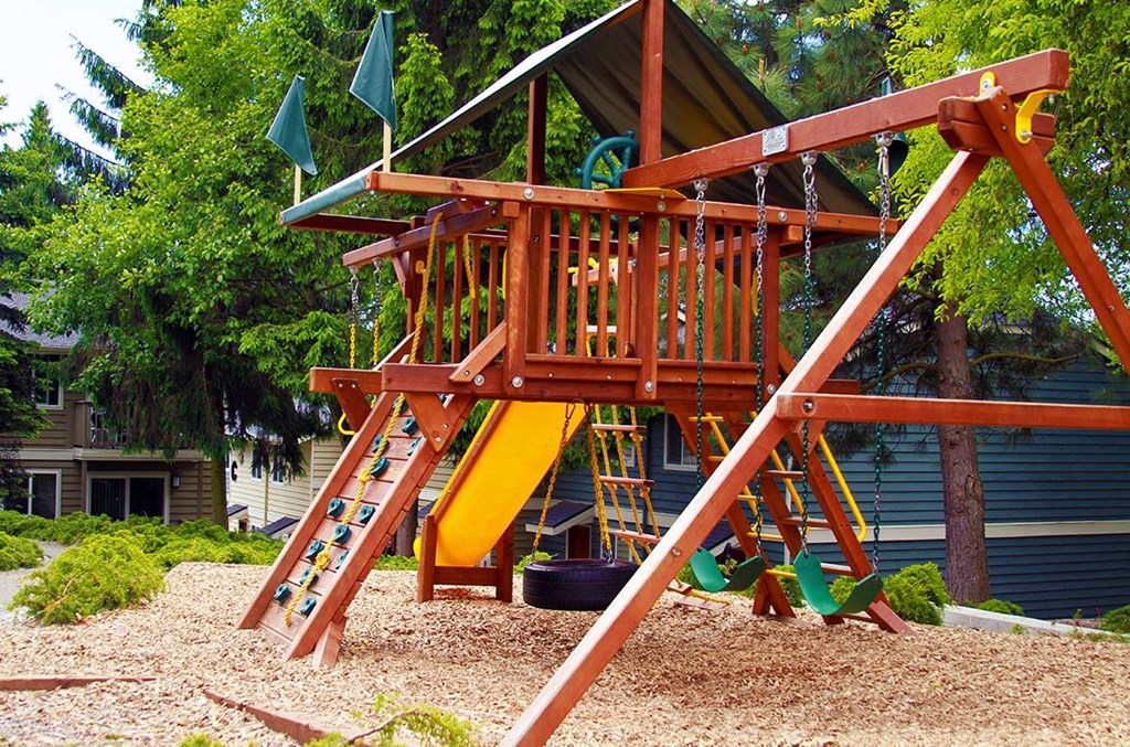 a playground with a swing set in a backyard