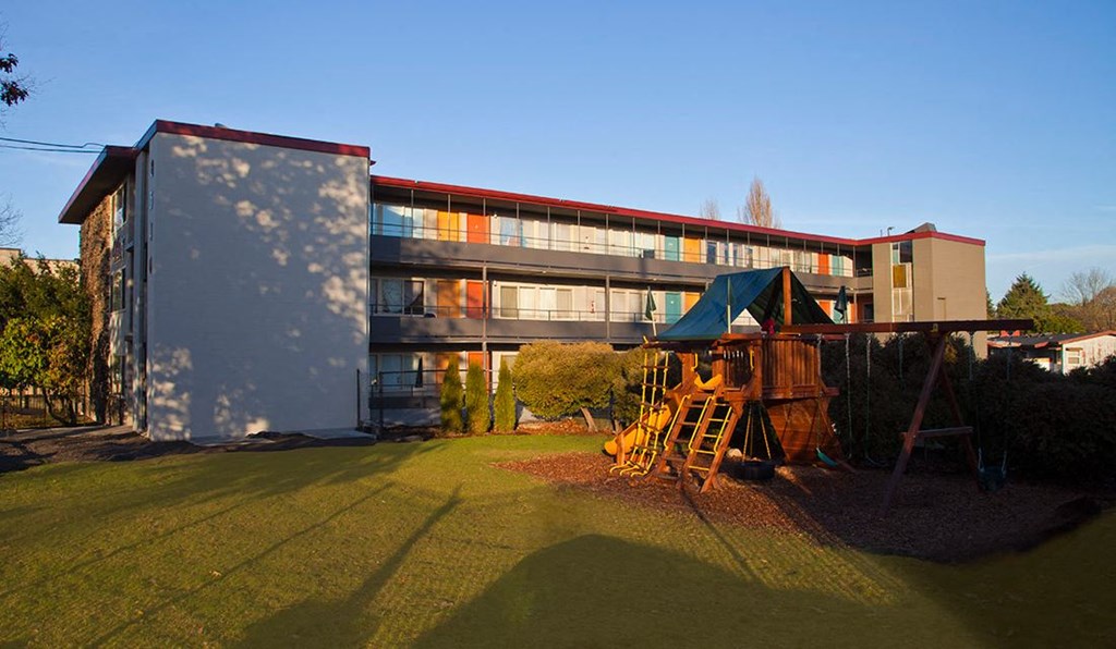 a childrens playground in front of a building