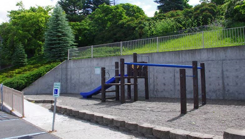 a childrens playground with a blue swing set