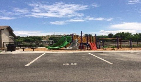 the playground is in the empty parking lot