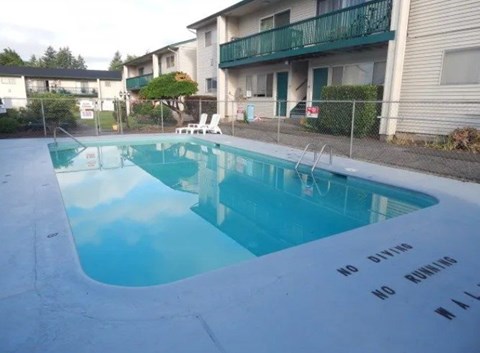 A pool with a sign that says "No Diving No Running".
