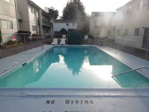 A pool with a "No Diving" sign in the foreground.