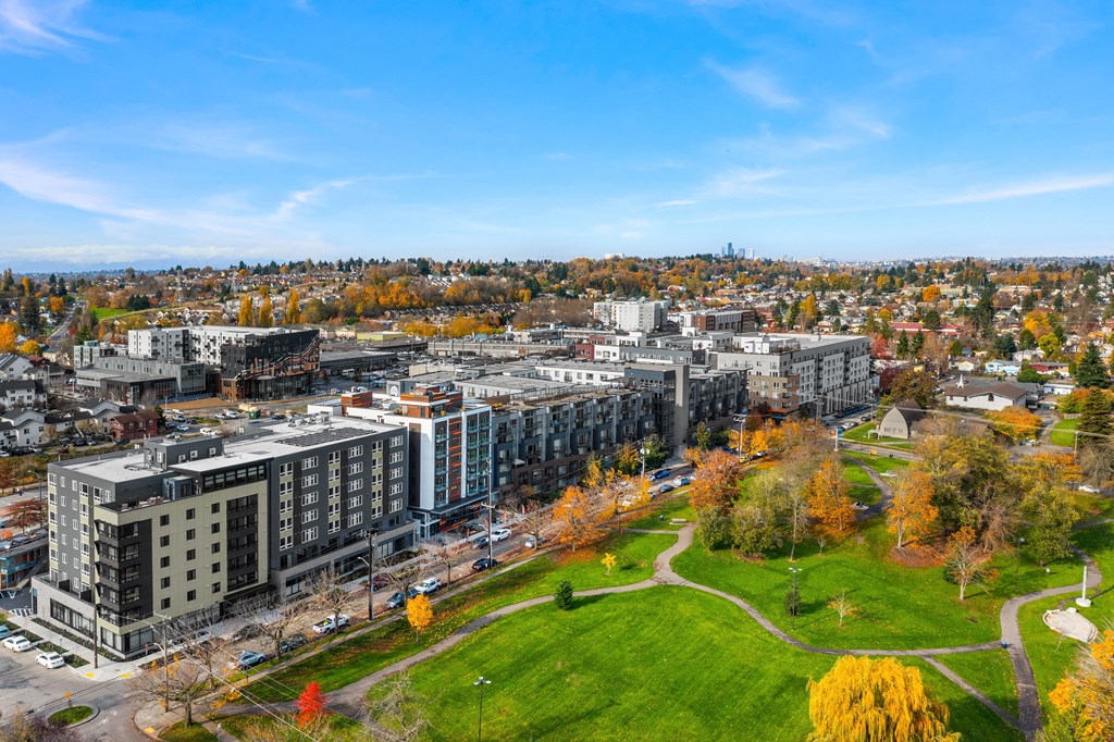 an aerial view of a city with buildings and a green park