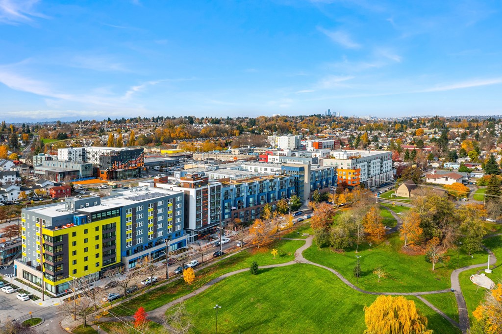 an aerial view of a city with buildings and a green park