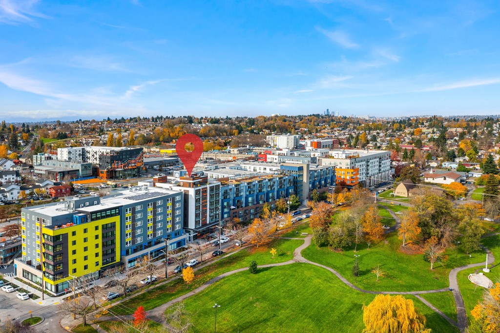 an aerial view of a city with a hot air balloon flying over it