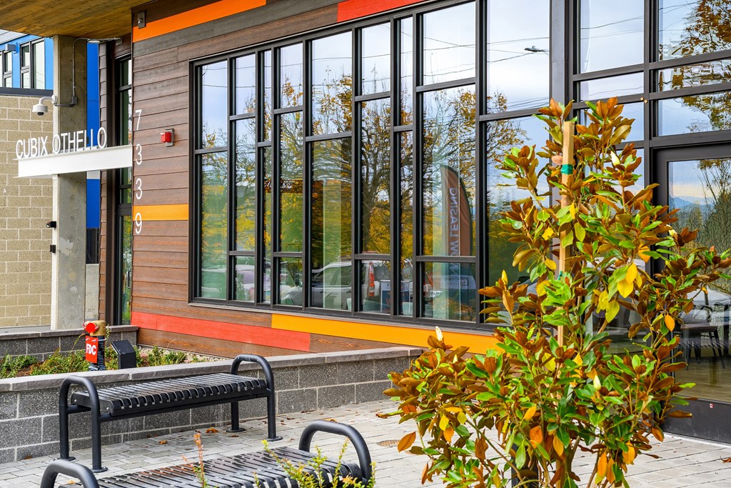 a bench in front of a building with large windows