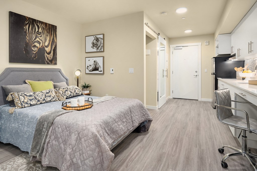 a bedroom with a bed and a desk