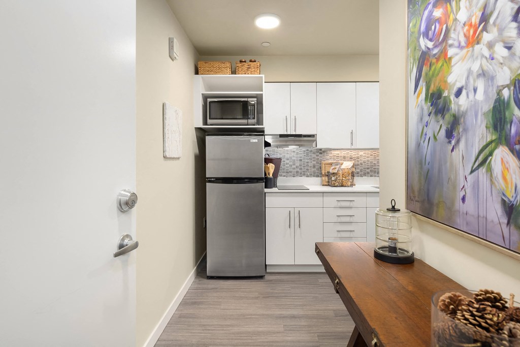 a kitchen with stainless steel appliances and white cabinets