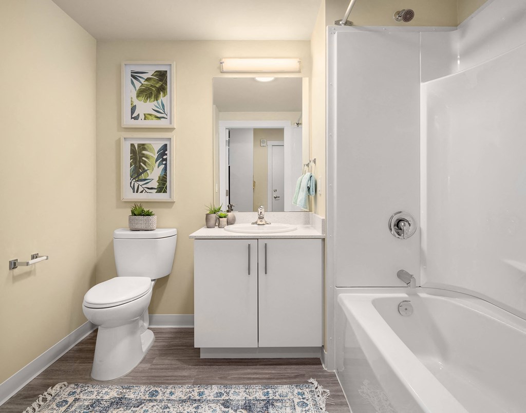 a bathroom with a toilet sink and shower