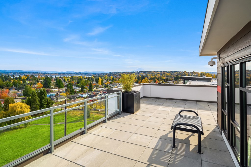 a balcony with a chair and a view of the city