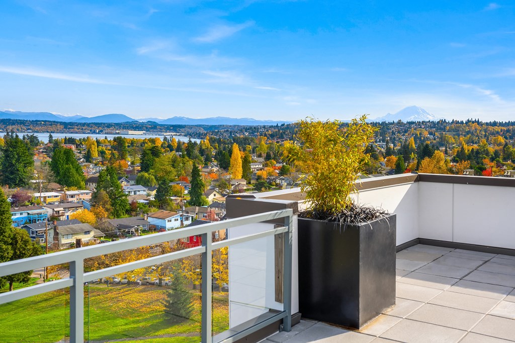a balcony with a view of the city and the mountains