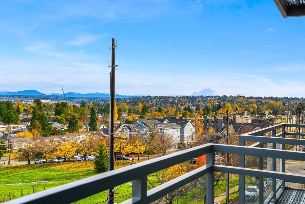 the view from the balcony of a building overlooking the city and mountains