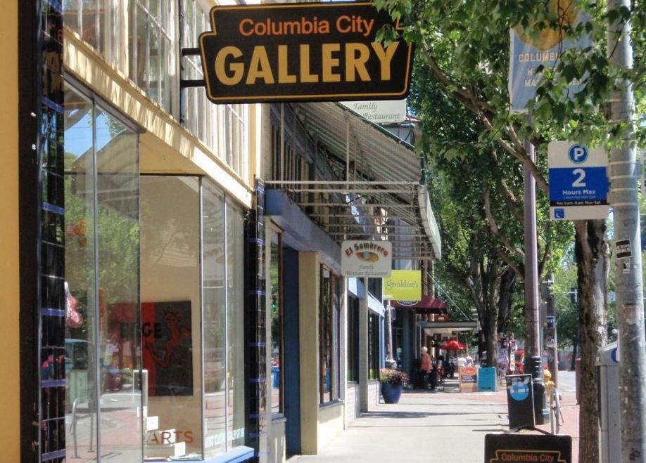 a sign for a gallery on a city street